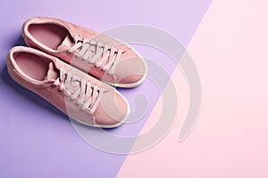 Bright stylish shoes on color background, top view.