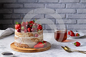 Bright summer cake with fresh berries on the table