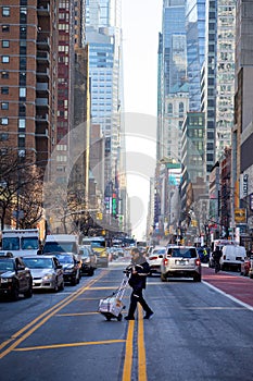 Man walking across center of new york city street