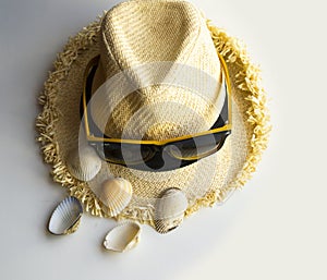 bright summer hat and sunglasses with shells