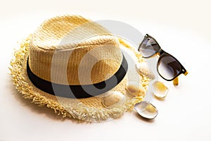 bright summer hat and sunglasses with shells