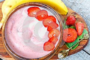 Bright summer strawberry-banana smoothie bowl.