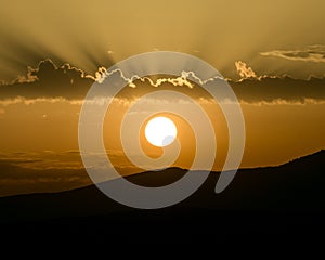 Bright summer sunrise and dramatic clouds