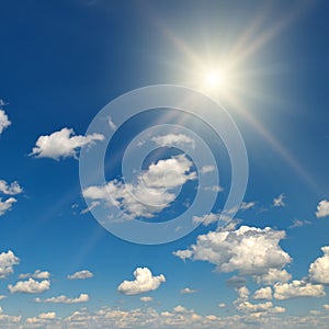 Bright sun on beautiful blue sky with white clouds