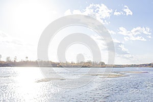 A bright sun in a blue sky. Autumn landscape on a bright sunny day. Sandy islands on the river