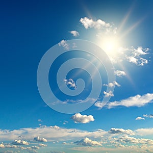 Bright sun on blue sky with beautiful clouds