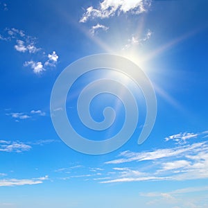 Bright sun, blue sky and light clouds