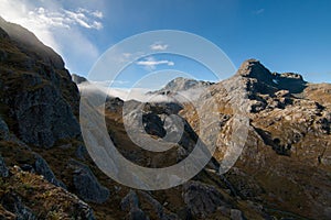 Bright sun light shining through cloud covered mountains, Mount Aspiring National Park, South Island New Zealand