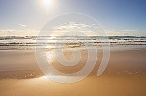 Bright Sun Rising Over Surf Waves Sand Background