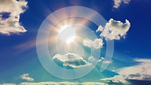 Bright sun in the sky among white fluffy clouds. The sun\'s rays in the blue sky. Generated by AI. International Sun Day.