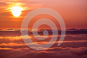 Bright sunlight reflected on a sea of clouds before sunset