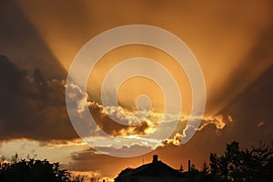 The bright sunlight of the setting sun over the house