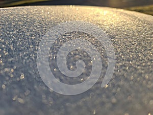 Bright sunlight on white frosty surface background