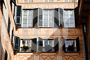 Bright Sunlit Painted House Facade in Genoa