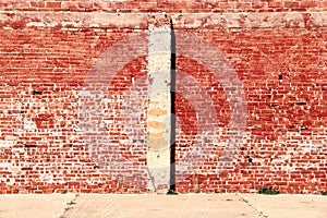 Bright sunlit vintage red brick building wall