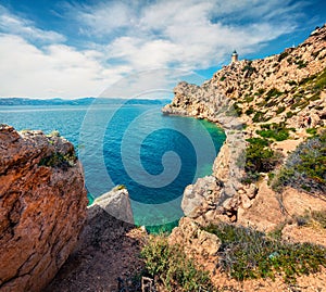 Bright sunny view of Melagavi lighthouse in the Corinth Gulf. Picturesque spring seascape in the Greece, Europe. Beauty of nature