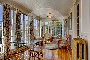 Bright sunroom with wicker furniture