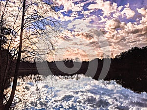 Bright Sunset with Clouds Over a Lake