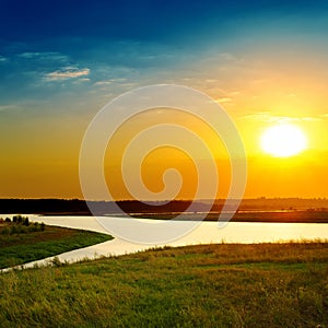 Bright sunset over river