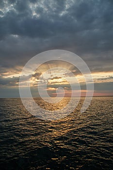 Bright sunset over the sea, upright photo