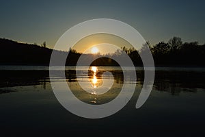 Bright sunset reflected in water