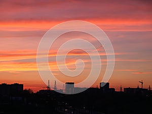 Bright sunset sky over the silhouette of the evening city. City of Lviv skyline at sunset