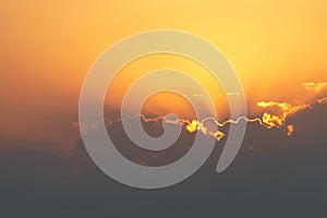 Bright sunset or sunrise sky with clouds and sunrays