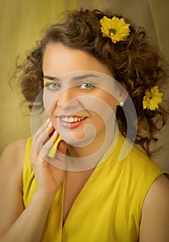 Bright sunshine lady in yellow dress with yellow flowers closeup.Art processing