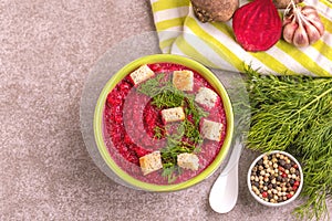Bright tasty pureed beetroot soup with ingredients. Healthy food