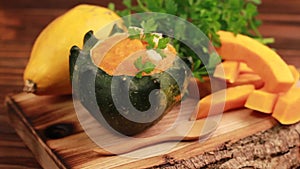 Bright tasty pureed pumpkin soup served in a hollowed pumpkin with ingredients
