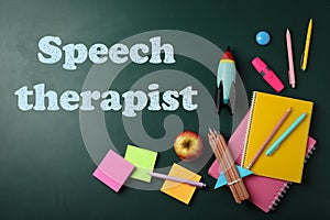 Bright toy rocket, school supplies and text Speech Therapist on chalkboard