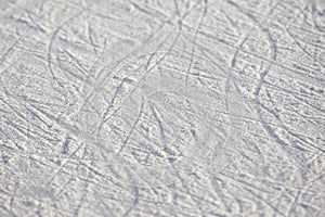 Bright traces of ice skating on an ice rink. background and texture