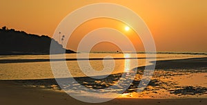 Bright tropical sunset at low tide in Goa, India