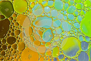 Colorful background of oil drops on the water surface.