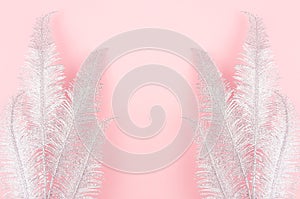 Bright vacation background with silver glitter palm branches as decorative border on pastel pink backdrop.