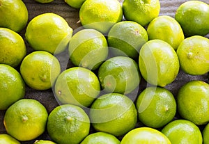 Bright vibrant green bunch of limes on a dark background