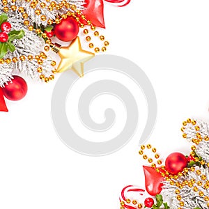 Bright vivid Christmas corner composition with red holly berries, glass baubles, golden garland and snowy Xmas tree branch