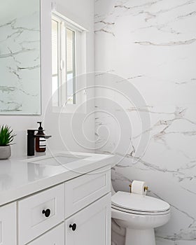 Bright white clean bathroom with marble walls