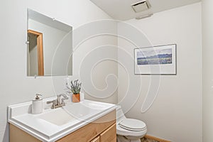 Bright white large small bathroom white counter vanity minimal mirror toilet