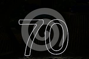 Bright White Neon Number 70 on Black Background