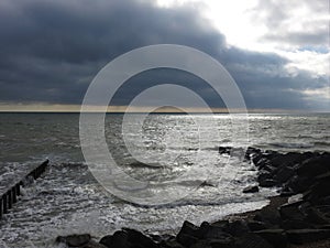Bright white sunlight breaking through dark clouds