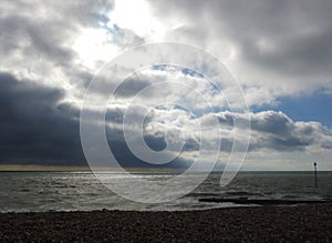 Bright white sunlight breaking through dark clouds