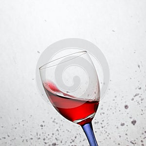 Bright wine in a tilted glass with a colored leg