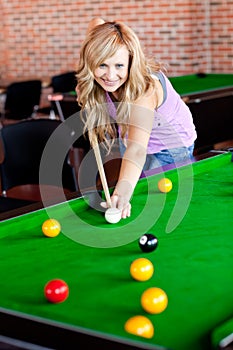 Bright woman playing pool