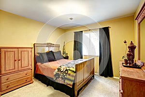 Bright yellow bedroom with carved wood furniture