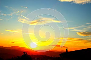 Bright yellow-blue sky with the setting sun in Monte Vidon Corrado