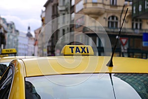 Bright yellow taxi in evening city photo