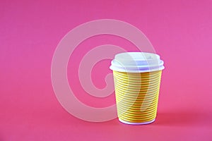 Colorful simplistic minimal composition with heat proof paper coffee cup. Take out tea mug with plastic cap. Coffee shop concept.