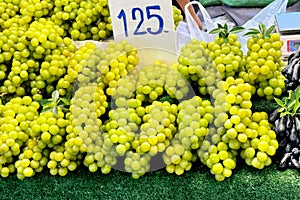 Bright yellow grape bunches for sale at a market