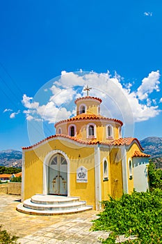Bright yellow Greek Orthodox small church Argostoli Kefalonia island Greece